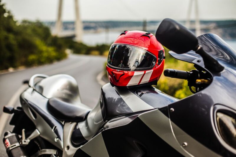 Black motorcycle and a red helmet on it