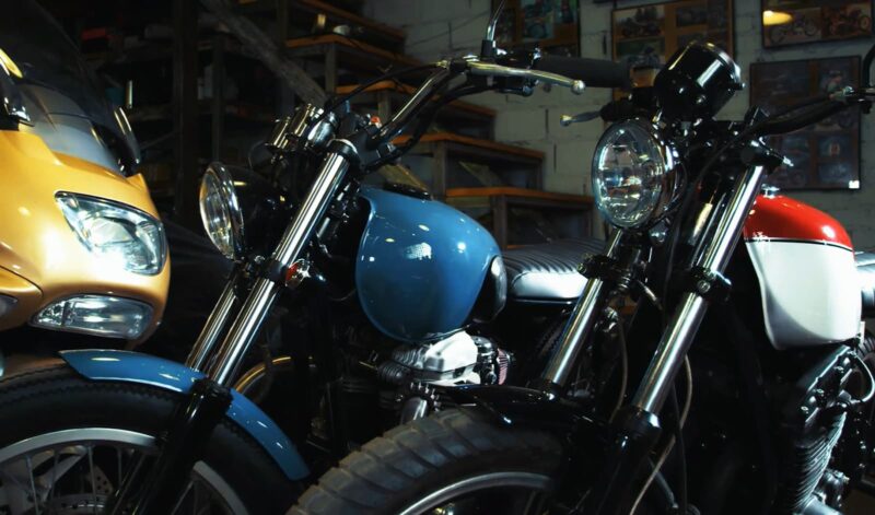 A lineup of classic motorcycles in a garage